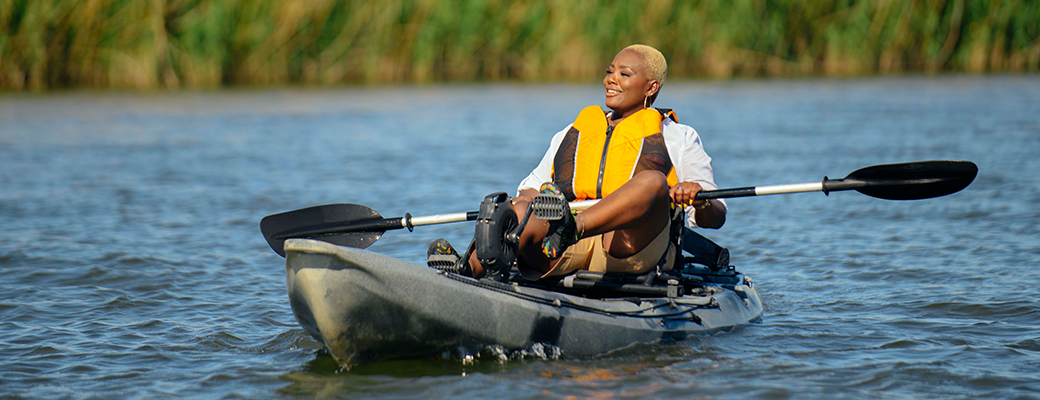 Image of female hearing aid wearer sailing on a kayak